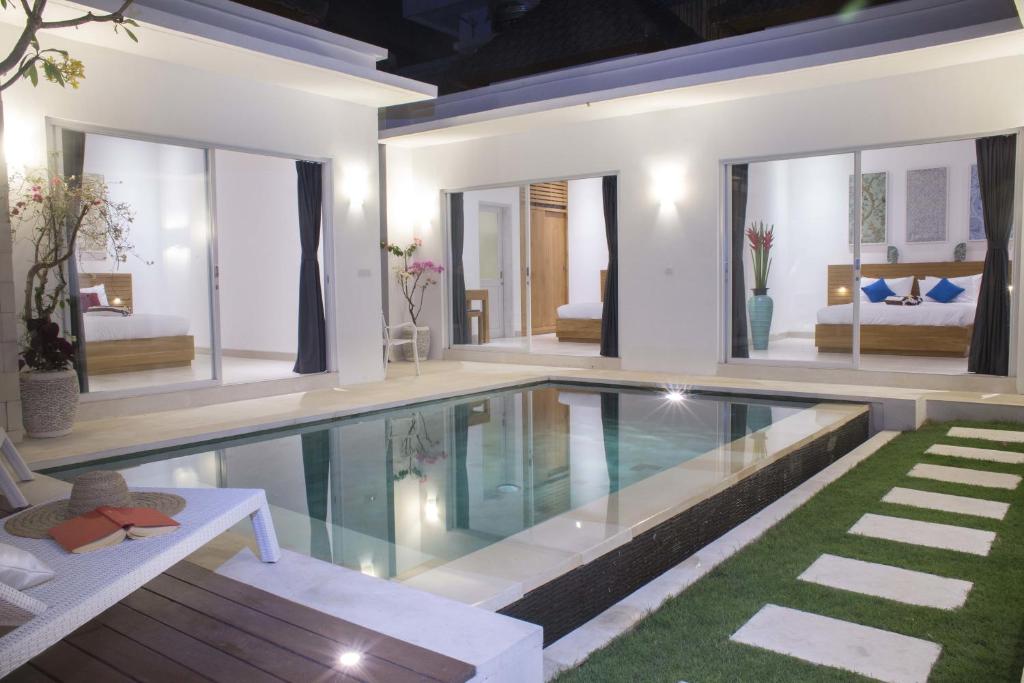 a swimming pool in the middle of a house at Villa Leda in Seminyak