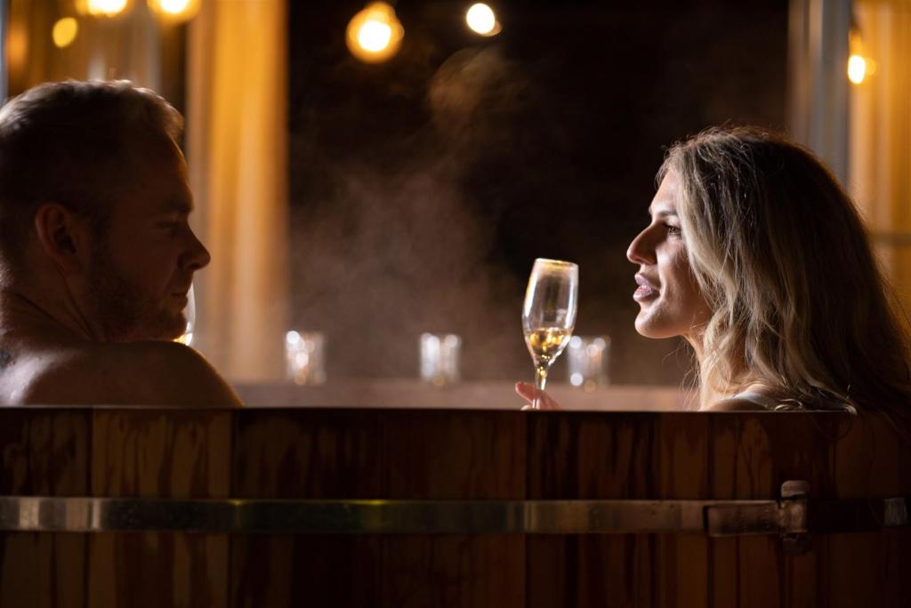 a man and a woman holding a glass of wine at The Joiners Arms in Chathill