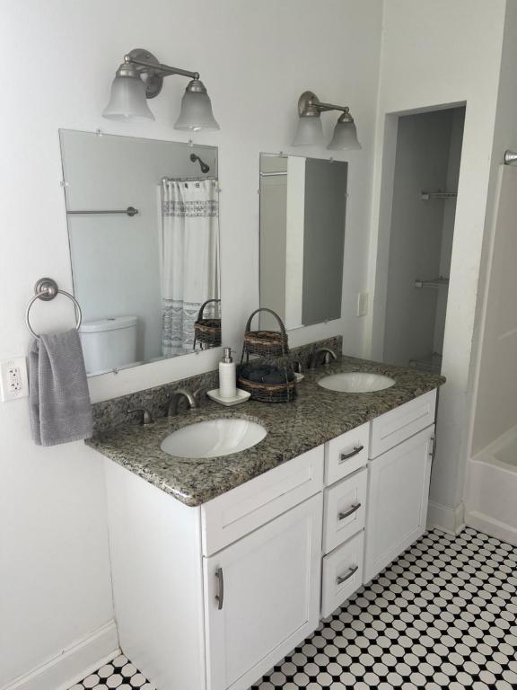 a bathroom with two sinks and a large mirror at New Orleans Home Sweet Home in New Orleans
