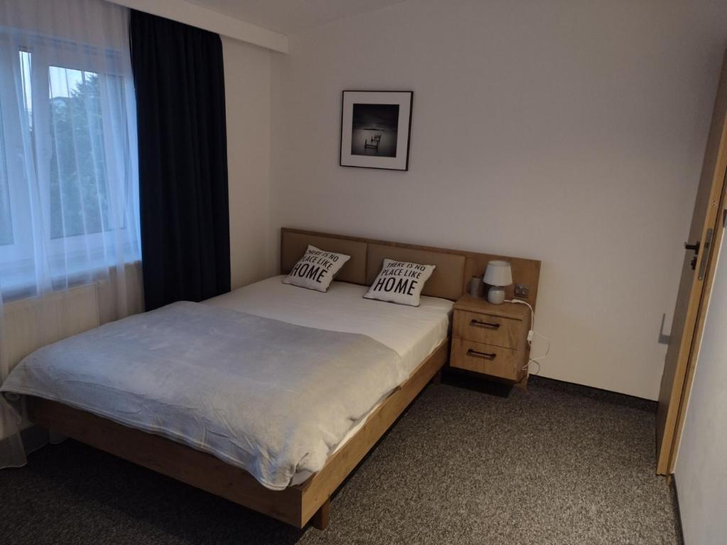 a bedroom with a bed with two pillows on it at Dom gościnny Krystyna in Władysławowo