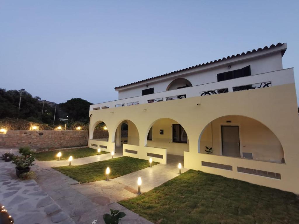 a villa with a courtyard at night at Villa Bianca in Chia