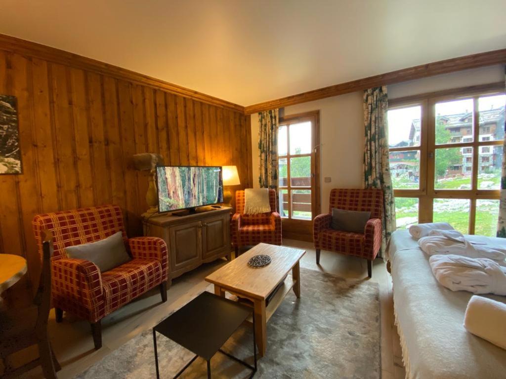 a living room with a couch and chairs and a tv at Petite Marmotte Spacieux Studio pour 4, Skis aux pieds, Le Refuge du Montagnard, Arc 1950 in Arc 1950