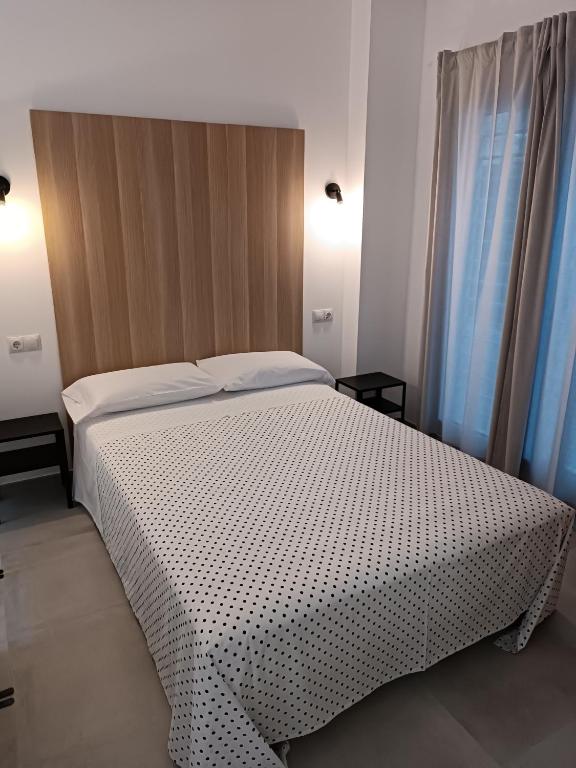 Postel nebo postele na pokoji v ubytování APARTAMENTOS LOS GUINDOS