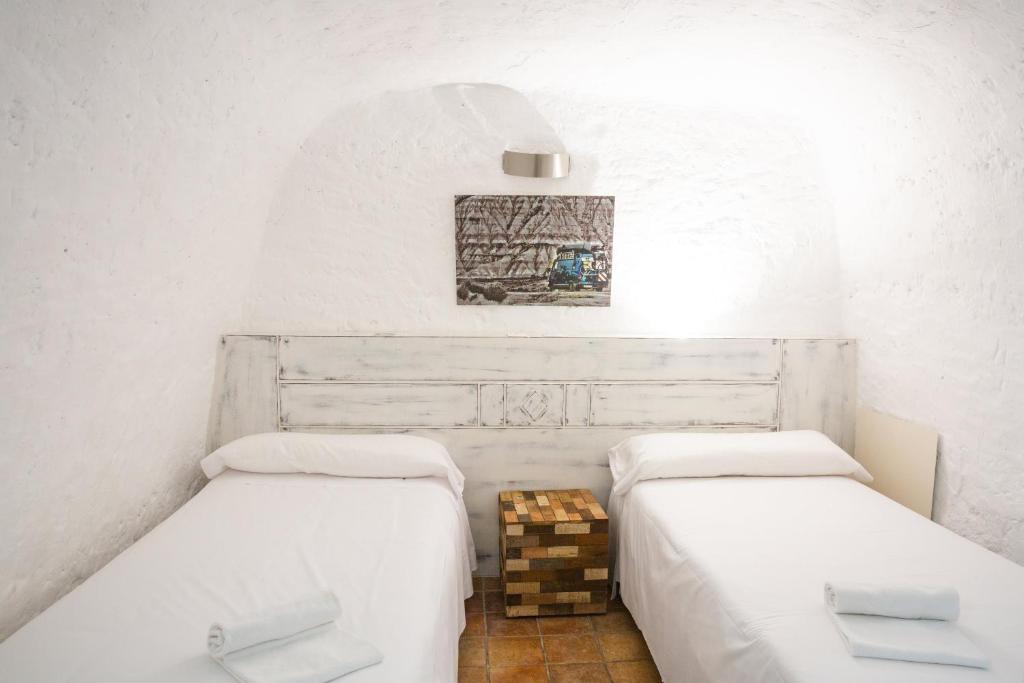 Postel nebo postele na pokoji v ubytování Cuevas de las Bardenas