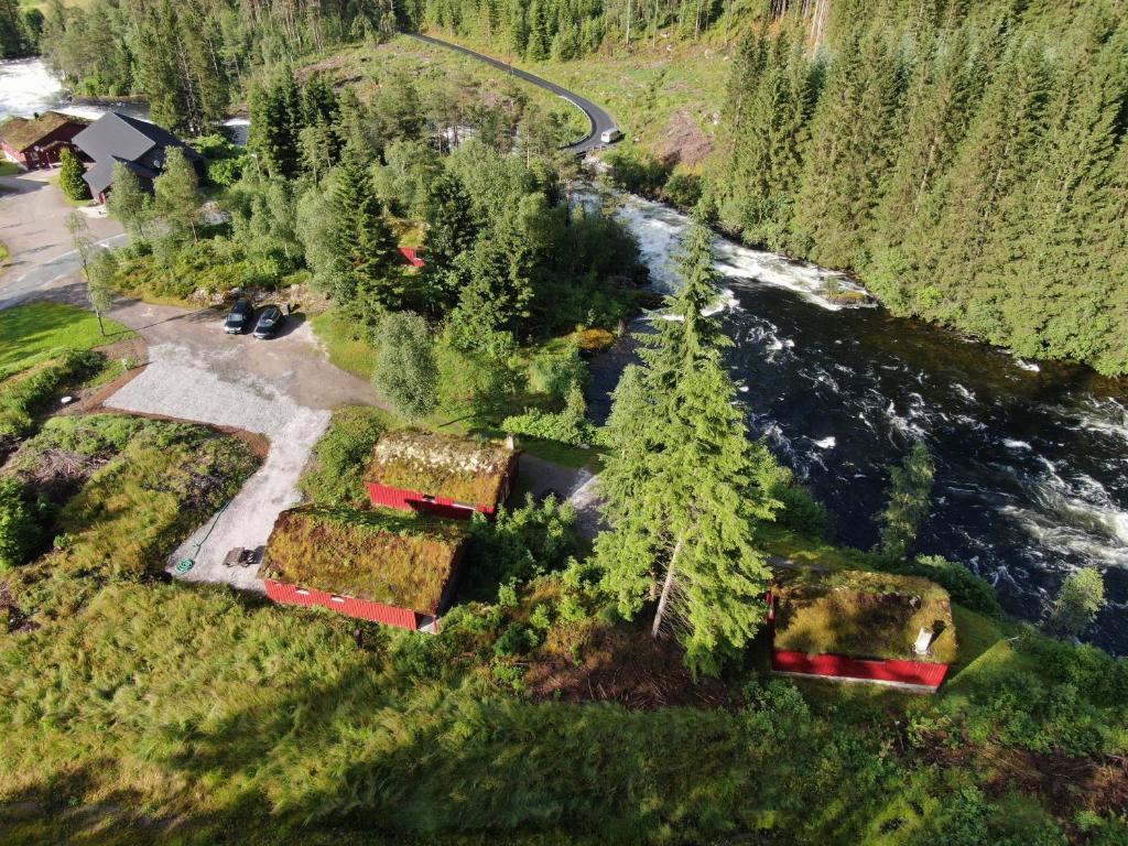 an aerial view of a house with trees next to a river at Døskeland in Sande