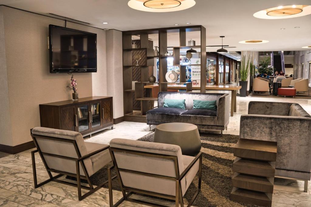 a lobby of a hotel with chairs and a couch at Holiday Inn Toronto Downtown Centre by IHG in Toronto