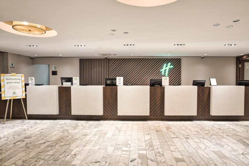 a lobby of a hotel with a reception desk at Holiday Inn Toronto Downtown Centre by IHG in Toronto