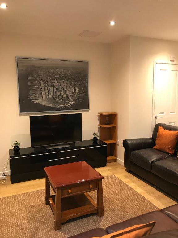 a living room with a couch and a coffee table at Apex Fox Street Apartment with Free Parking in Glasgow