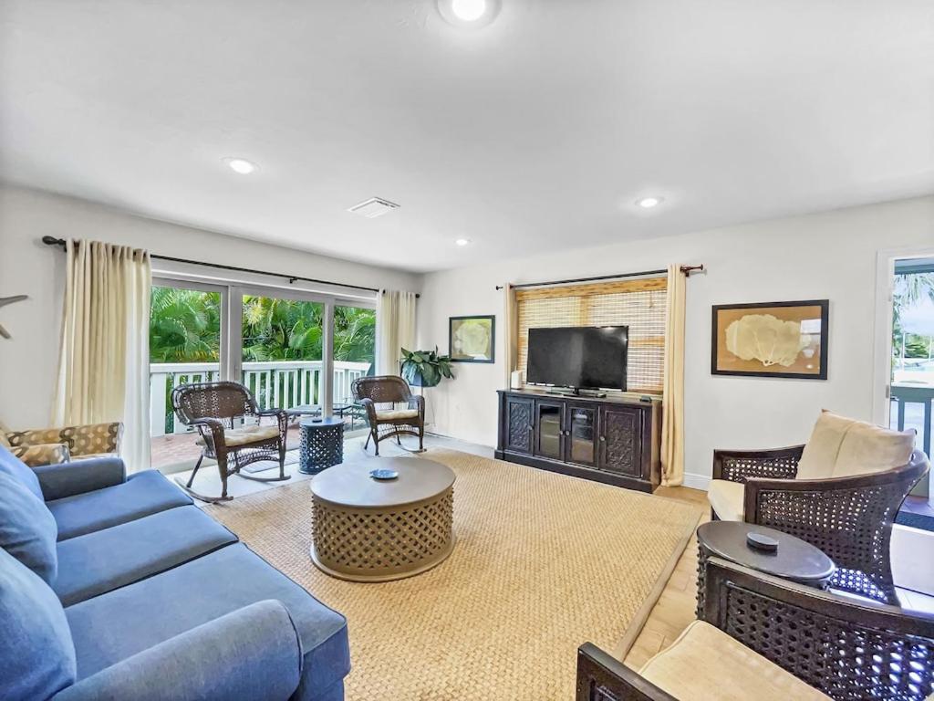 a living room with a blue couch and a tv at Spacious Updated Condo Just 2 Blocks to Siesta Key Beach in Siesta Key