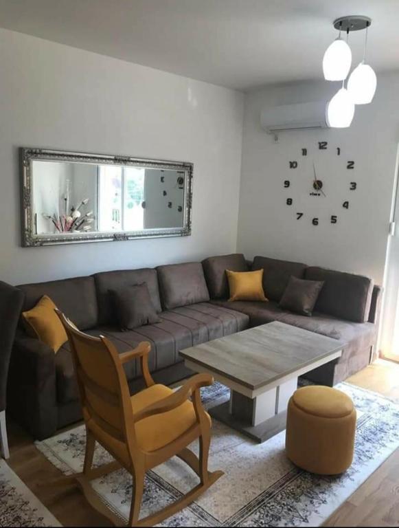 a living room with a couch and a table at KENZA jednosobni stanovi in Podgorica
