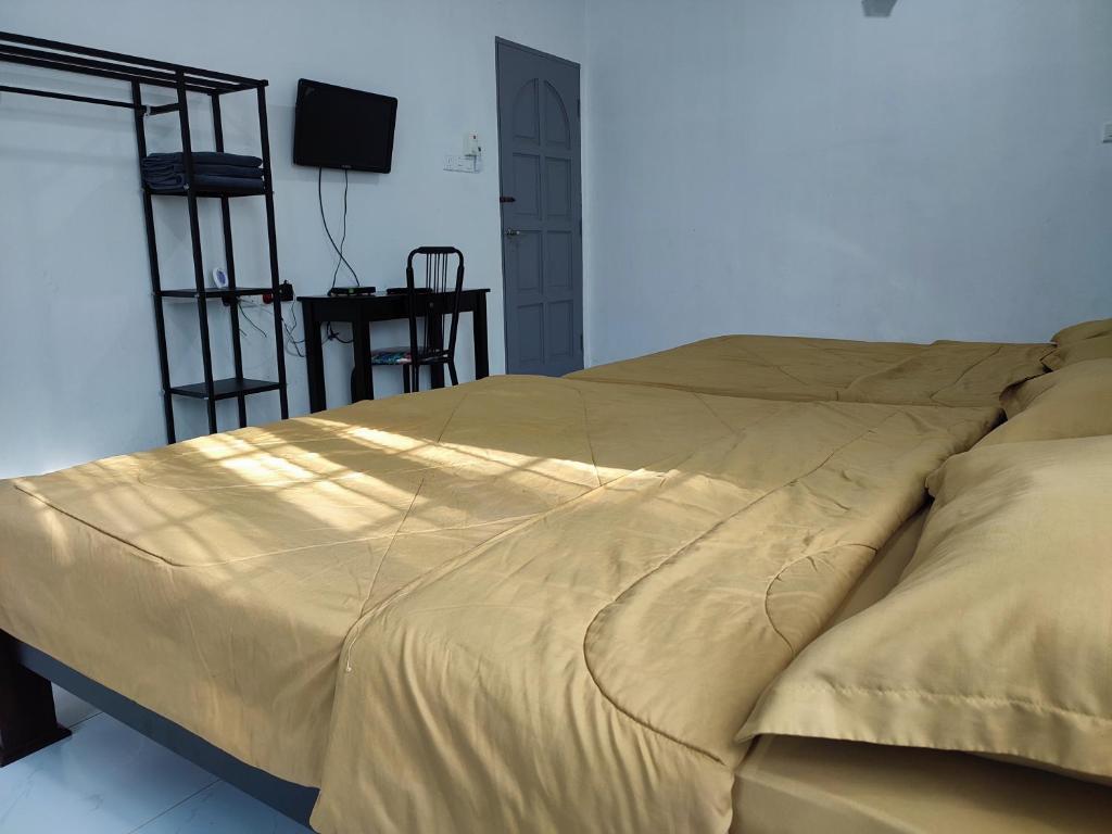 Postel nebo postele na pokoji v ubytování Kayangan Inn