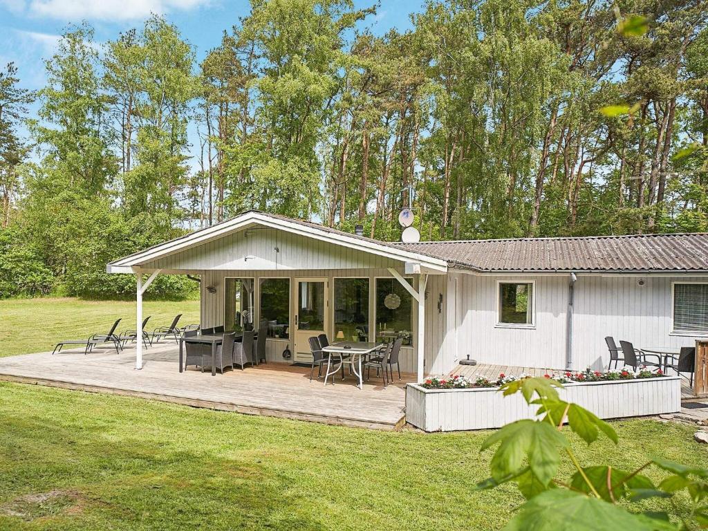 a white house with a porch and a patio at 6 person holiday home in Nexø-By Traum in Neksø