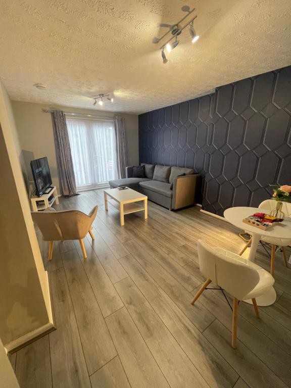 a living room with a couch and a table at Cosy, modern Apartment in Darlaston