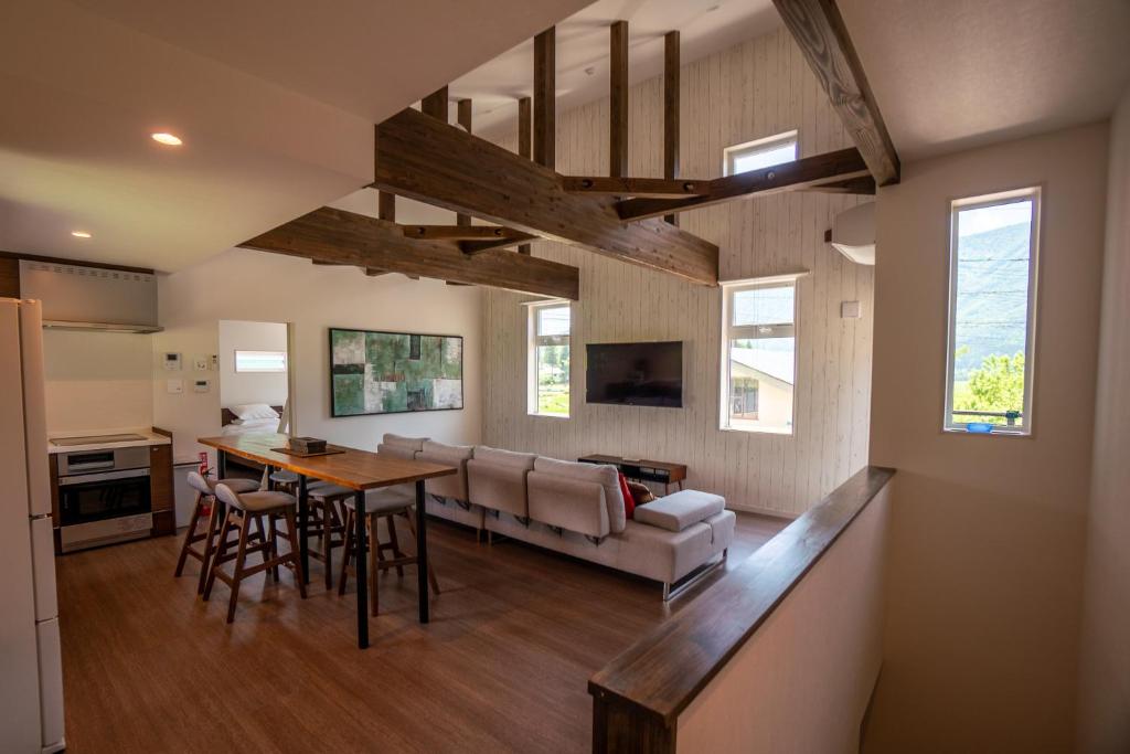 a kitchen and living room with a table and a couch at Hakuba View Villa in Hakuba