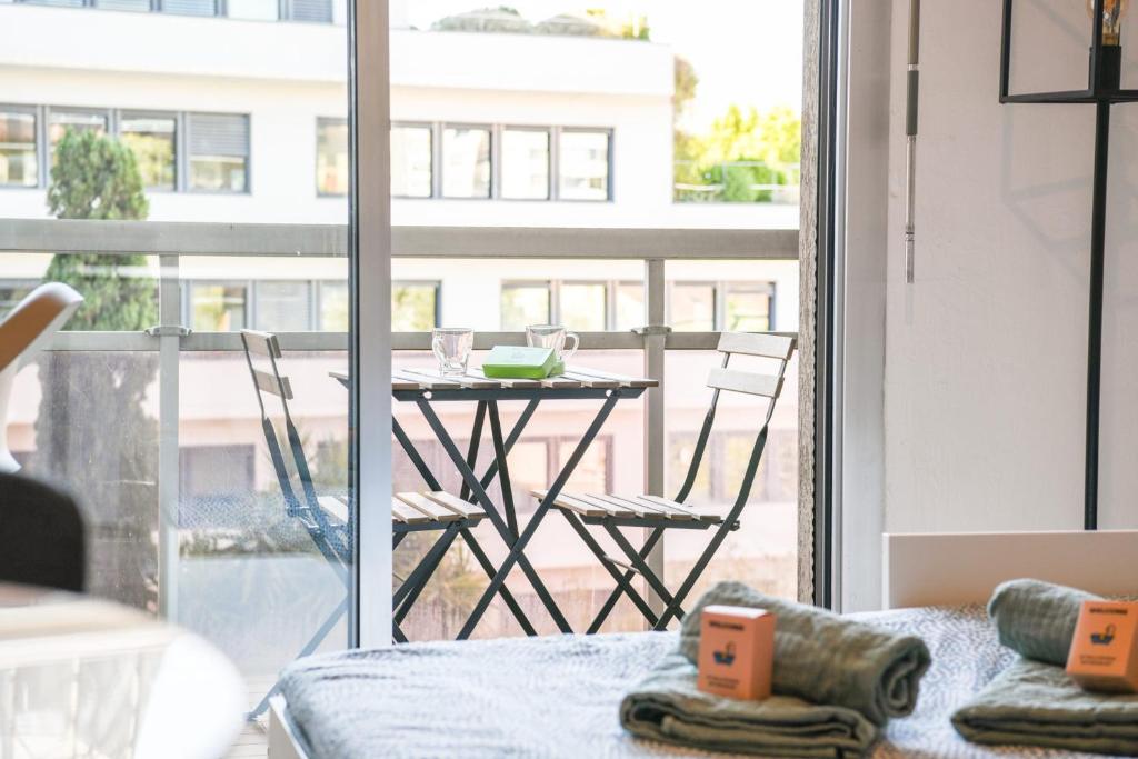 a living room with a table and a view of a balcony at Prado I - Coeur Perrier balcon proche Velodrome in Marseille