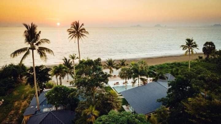a view of a beach with palm trees and a resort at Purin Resort & Restaurant- SHA Plus in Had Yao Beach