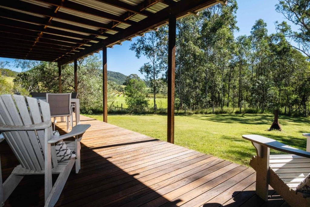 a wooden deck with two chairs and a table at Yarramie in Mount View