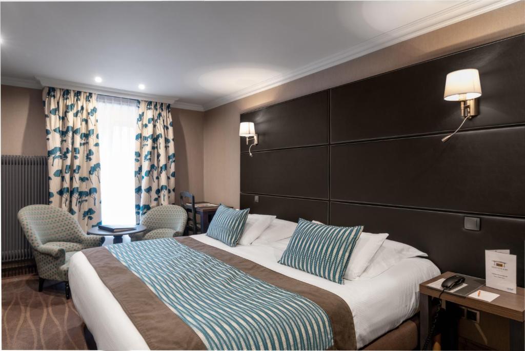 Postel nebo postele na pokoji v ubytování Le Grand Hotel & Spa
