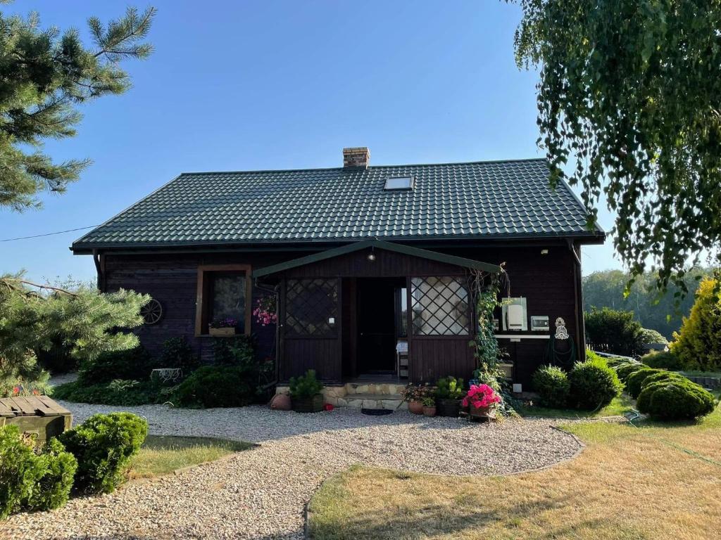 a small brown house with a roof at Farma Aktywnego Wypoczynku DagaSpa in Repki