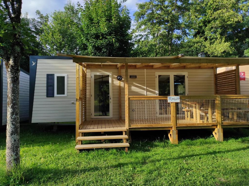 a log cabin with a porch and a deck at Family&#39;s Camping Le Savoy in Challes-les-Eaux