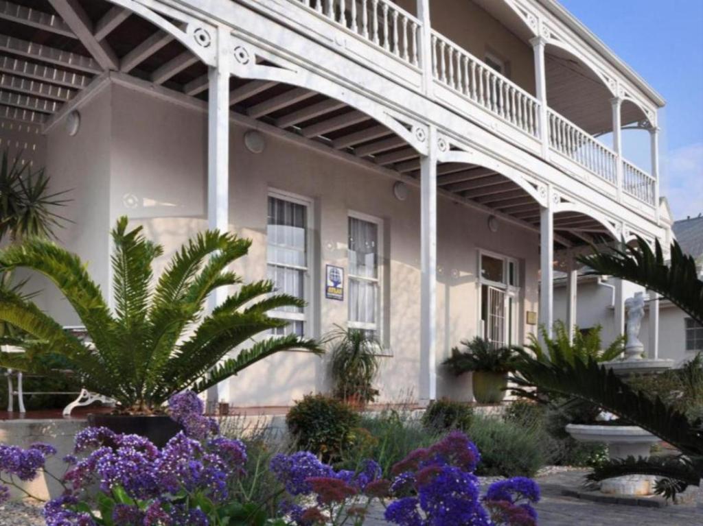 a building with purple flowers in front of it at St Phillips Bed & Breakfast in Port Elizabeth