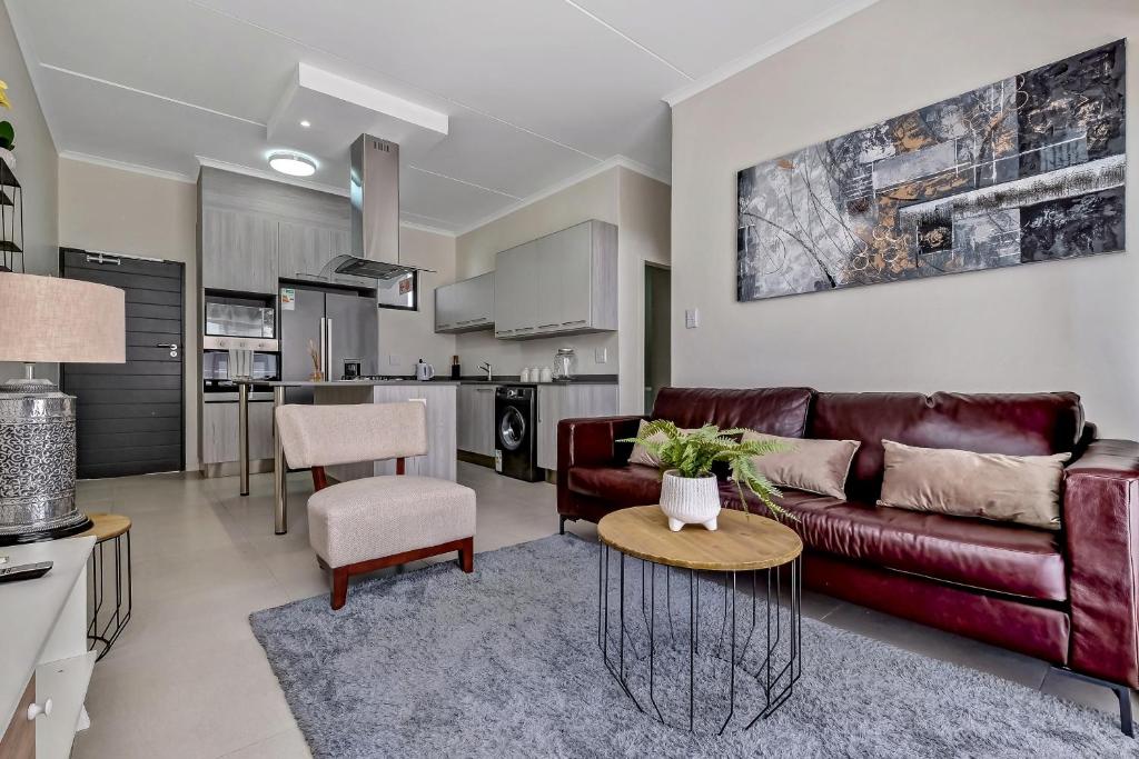 un salon avec un canapé et une table dans l'établissement Smart Apartment, à Midrand