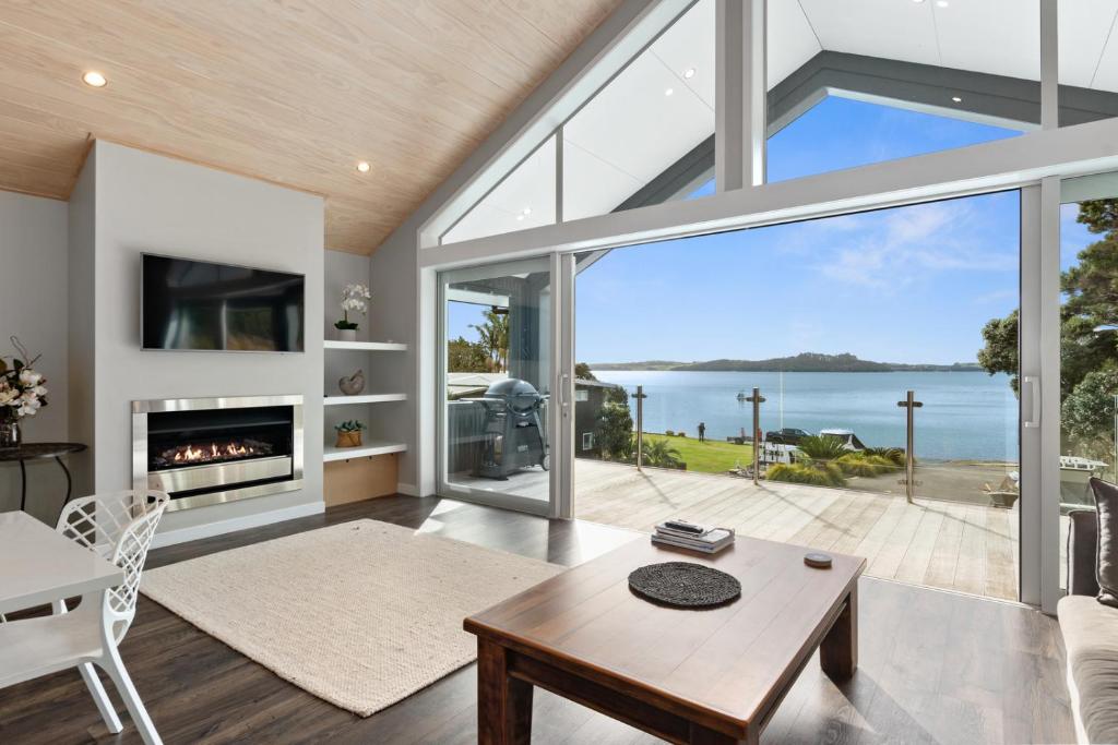 a living room with a view of the ocean at Seaside Serenity - Kerikeri Holiday Home in Kerikeri