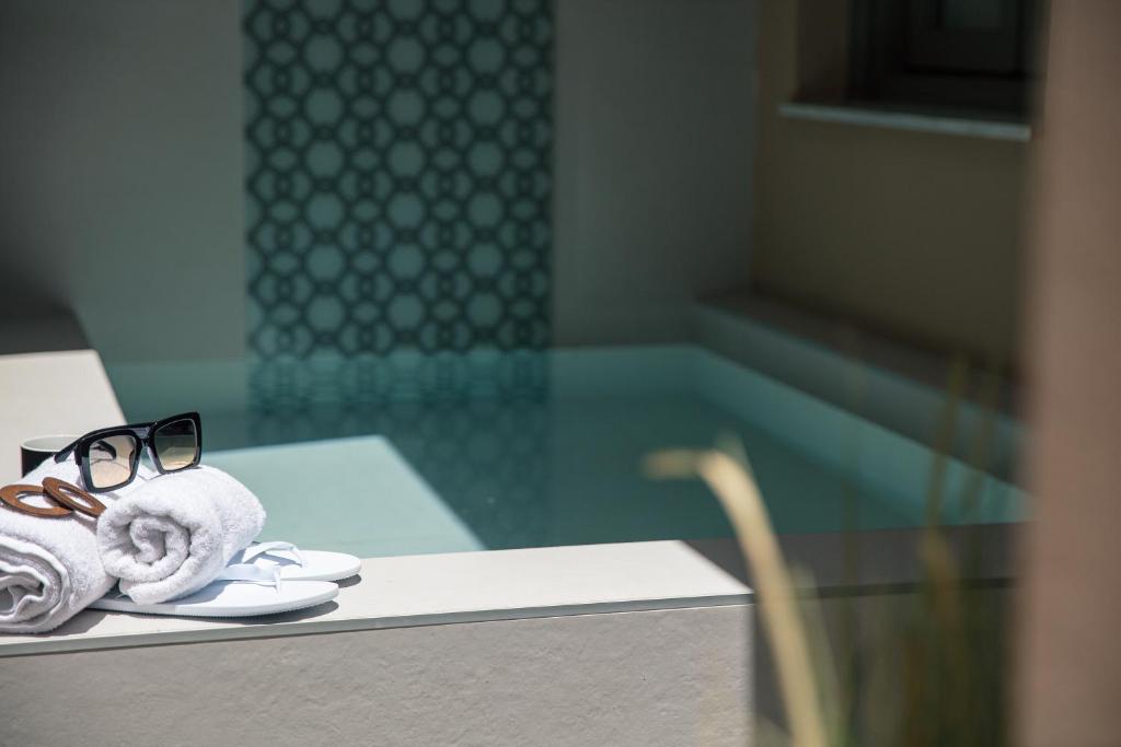 a pair of glasses sitting on top of a table at Gateway Suites in Rethymno