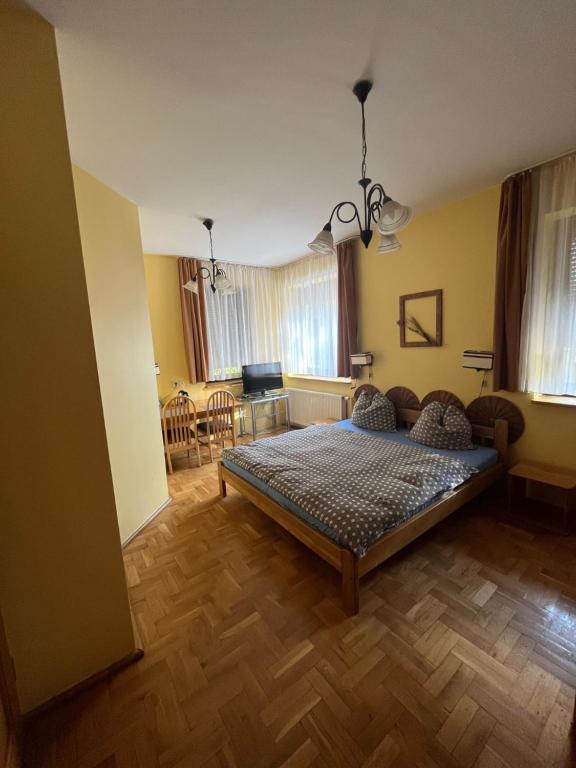 a bedroom with a bed and a dining room at Villa Senator with access Kitchen - Adults Only in Zielona Góra