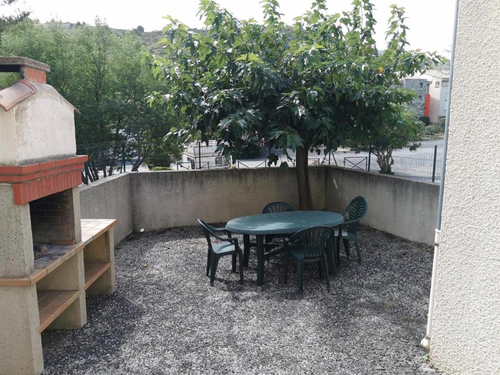 a table and chairs and a tree on a patio at Desix 