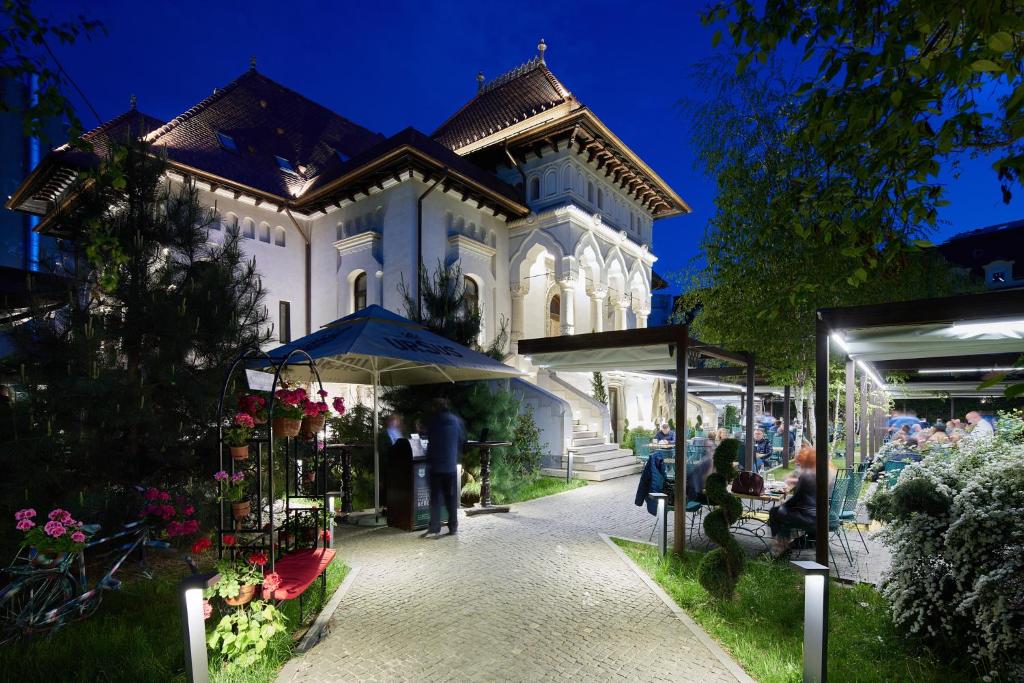 a group of people standing in front of a building at La Boheme in Bucharest