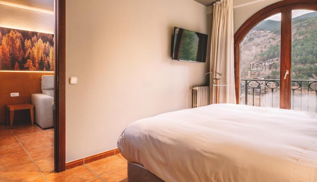 Postel nebo postele na pokoji v ubytování Abba Xalet Suites Hotel
