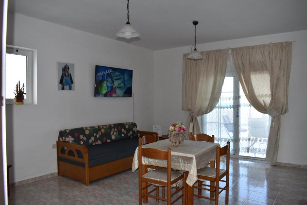 a living room with a table and a couch at Xenios Zeus Hotel in Karpathos