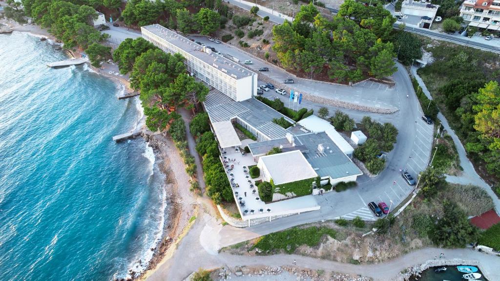 an aerial view of a building next to the ocean at Holiday Village Sagitta - Light All Inclusive in Omiš