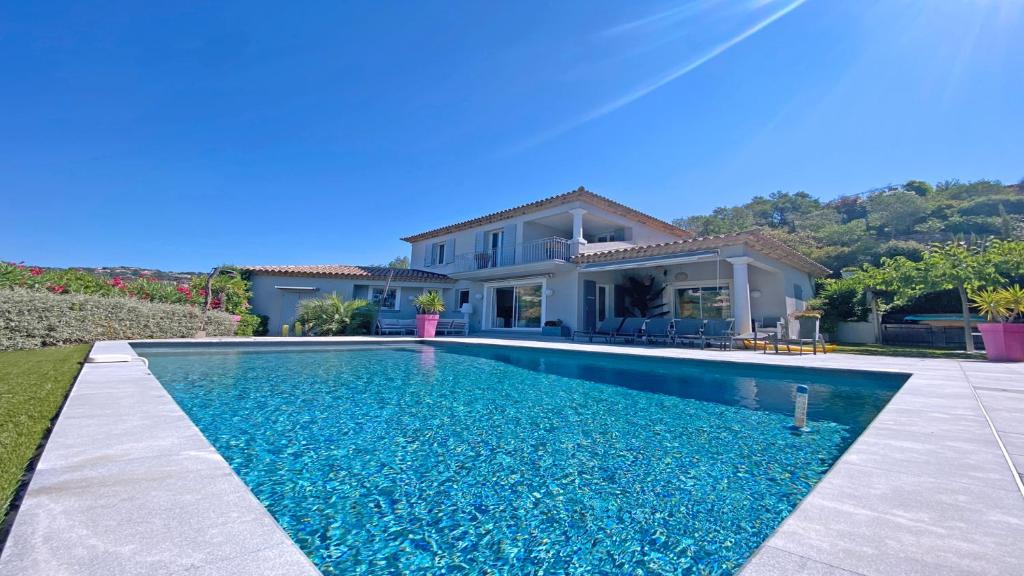 a villa with a swimming pool in front of a house at Villa Jade in Sainte-Maxime
