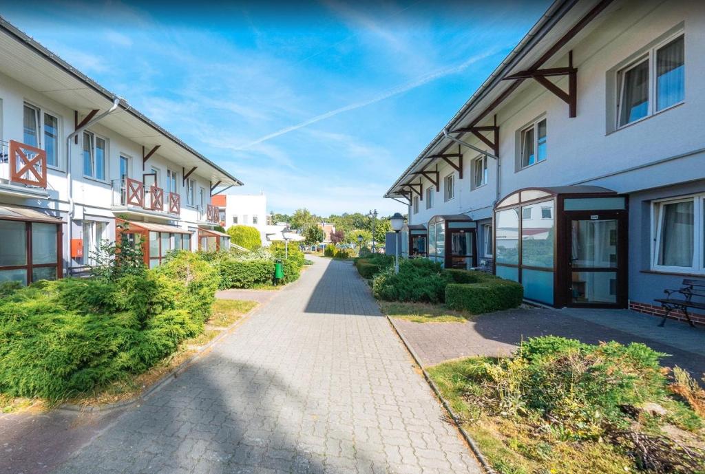 a walkway between two buildings in a city at Dozamel in Kołobrzeg