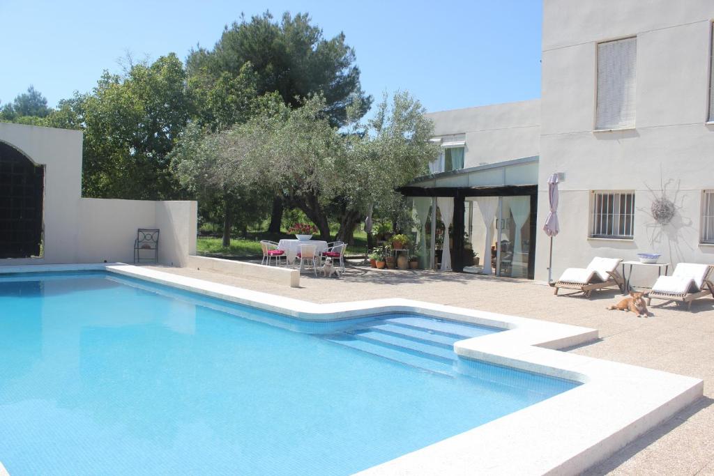 a swimming pool in front of a house at 032 Villa Albardanera in Pedreguer