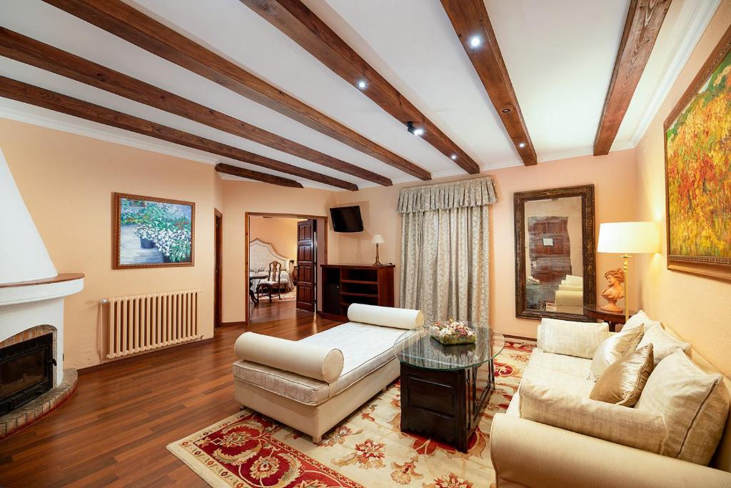 a living room with a couch and a fireplace at Rigat Park & Spa Hotel - Adults Recommended in Lloret de Mar