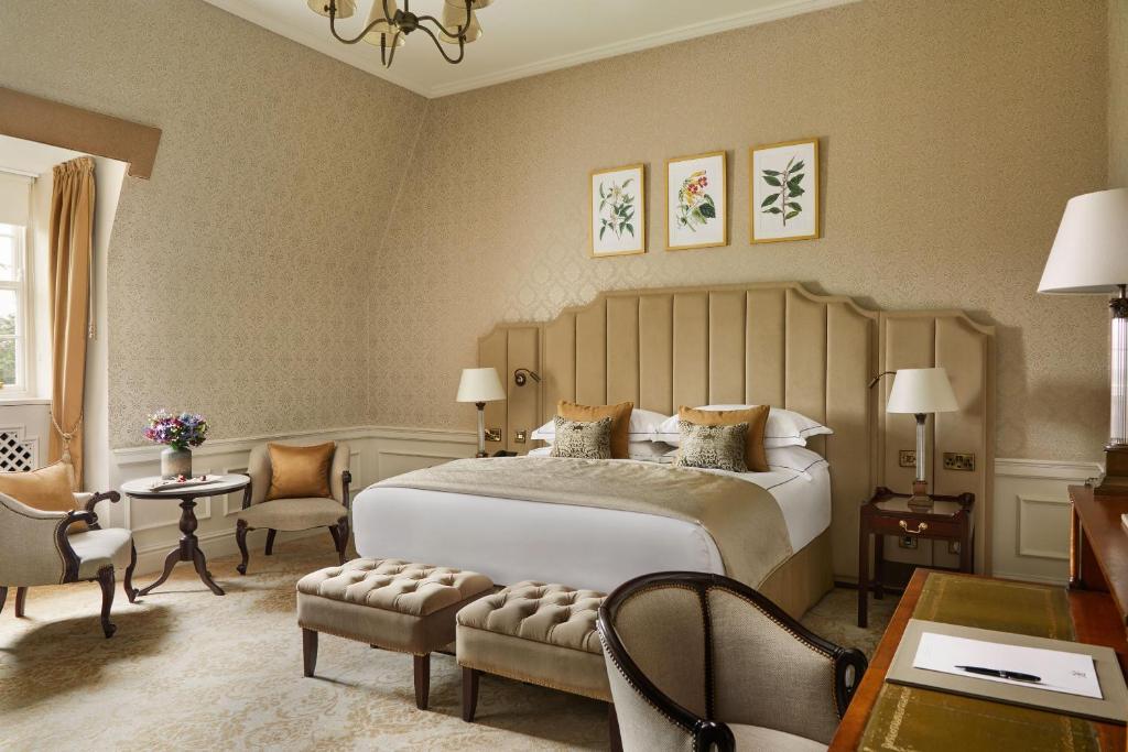 Elegant hotel room with classic decor, featuring a king-sized bed and stylish furnishings.