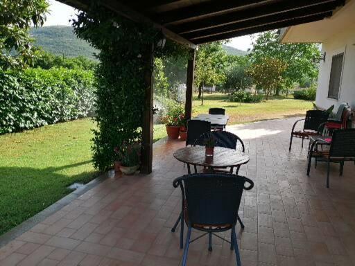 a patio with tables and chairs on a patio at B&B Il Tiglio in Padula