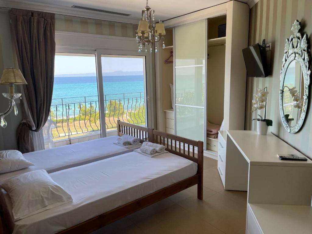 una camera da letto con un letto e vista sull'oceano di Plaza Hotel a Hanioti