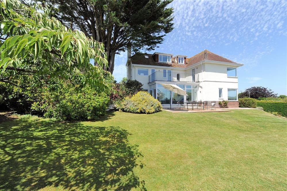 a large white house with a large yard at Somerhill in Lyme Regis