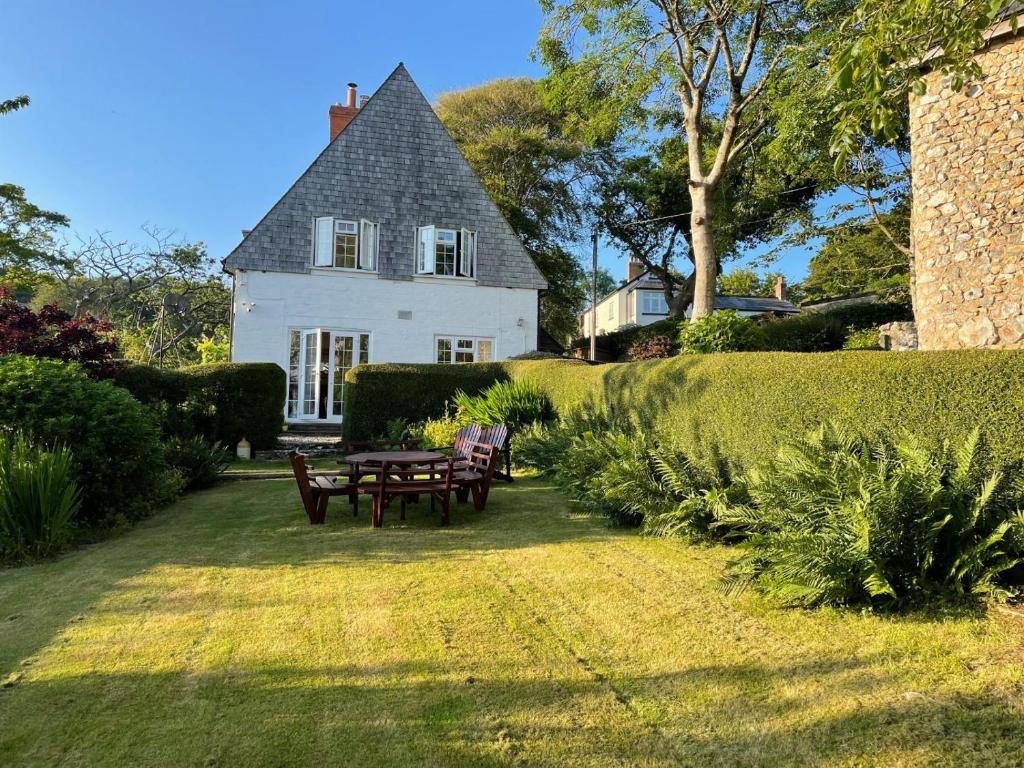 a white house with a picnic table in front of it at Barn Close Farm in Morecombelake