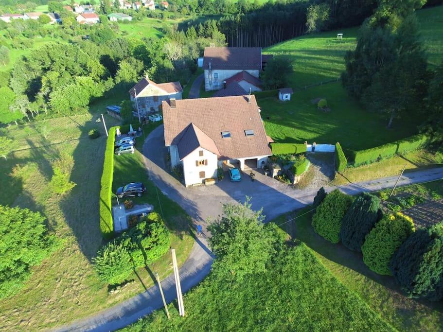 an aerial view of a house in a field at gite chez Maise in Le Val-dʼAjol