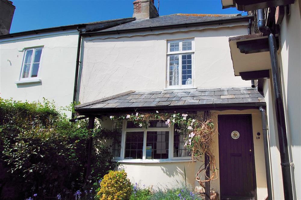 a white house with a purple door at Ivy Cottage in Lyme Regis