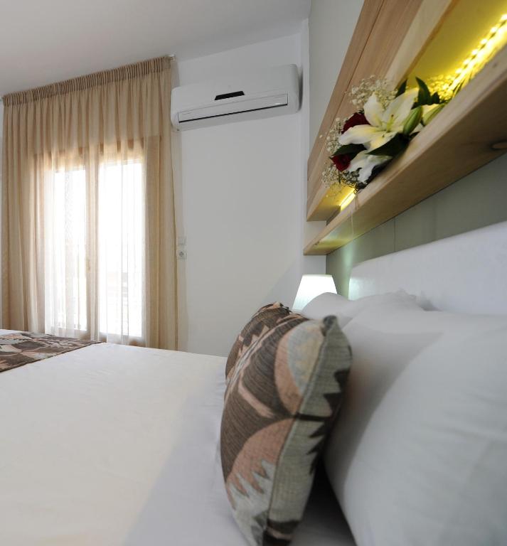 Łóżko lub łóżka w pokoju w obiekcie Stamatia Apartments