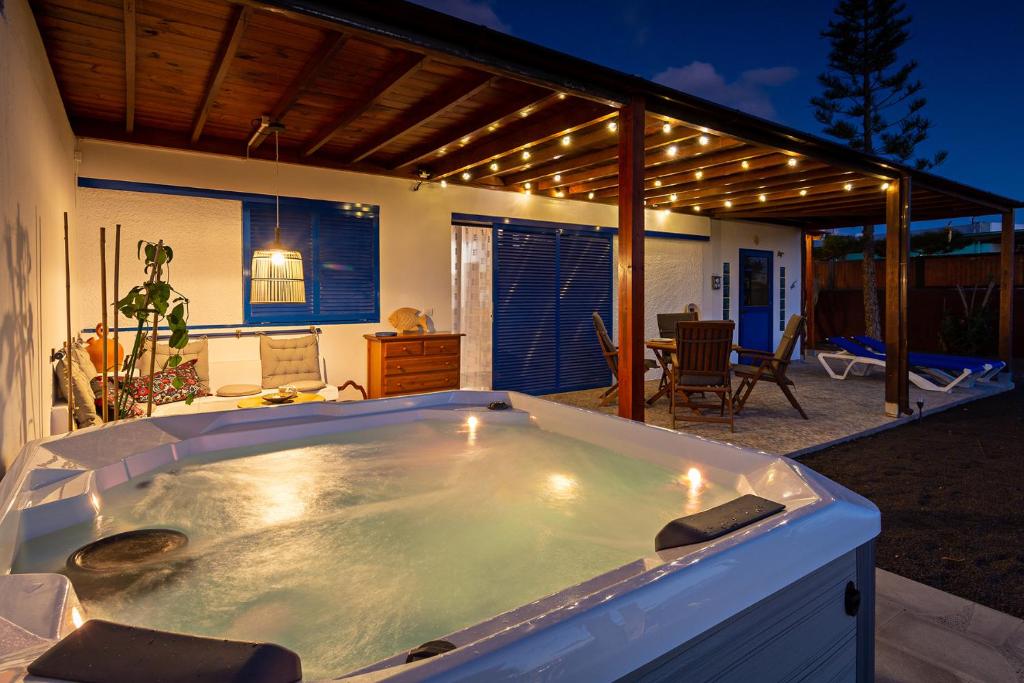 a large jacuzzi tub sitting on a patio at Villa Pilak in Playa Blanca