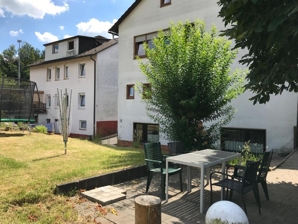 a table and chairs in front of a house at Generations Holiday Green Views in Attendorn