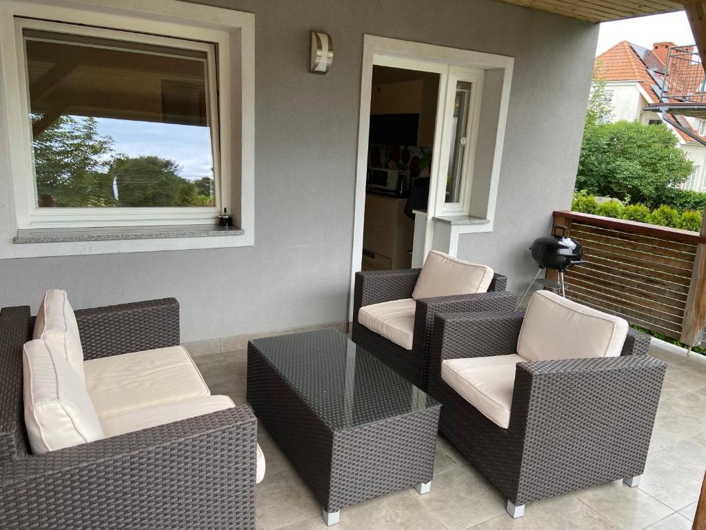a patio with chairs and a table and a window at Villa Arkodes in Gdańsk