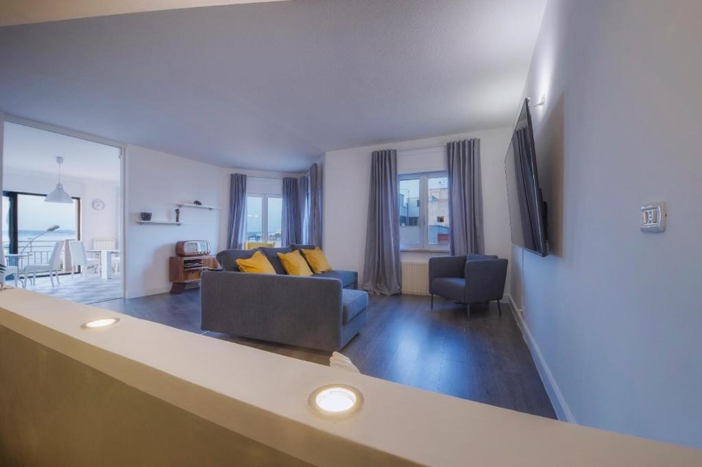 a living room with a couch and a television at B&B "La Vista Preziosa" Feeling Home in Gallipoli